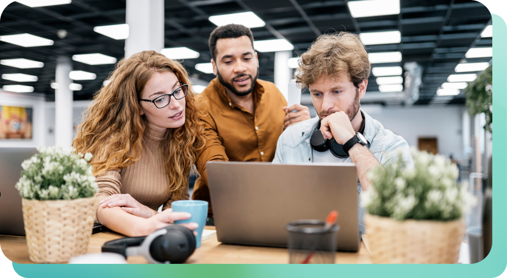 co-workers discussing sonic branding at a computer in the office