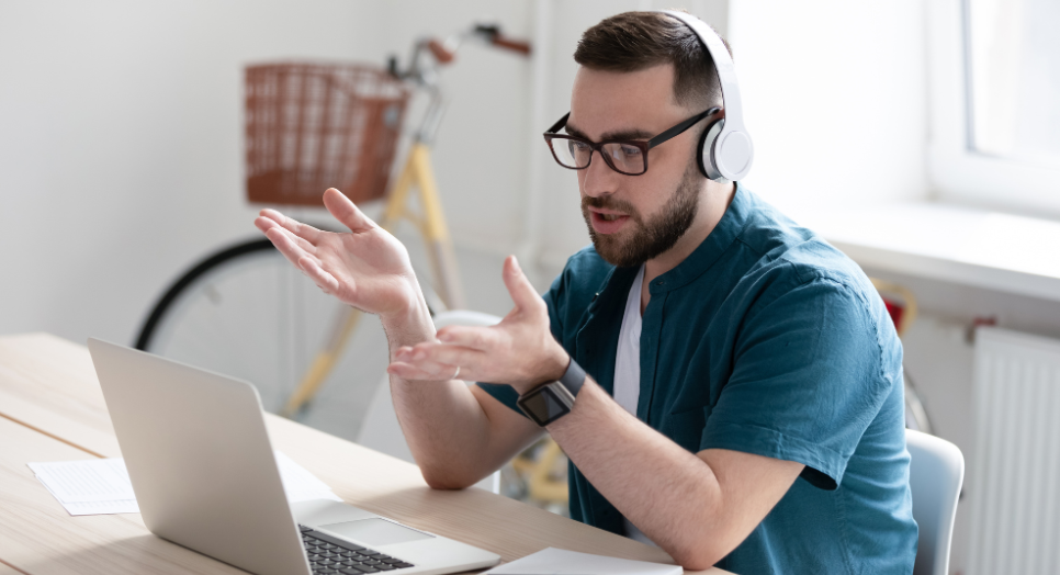 Man in office on a video call asking questions about how to license music for apps