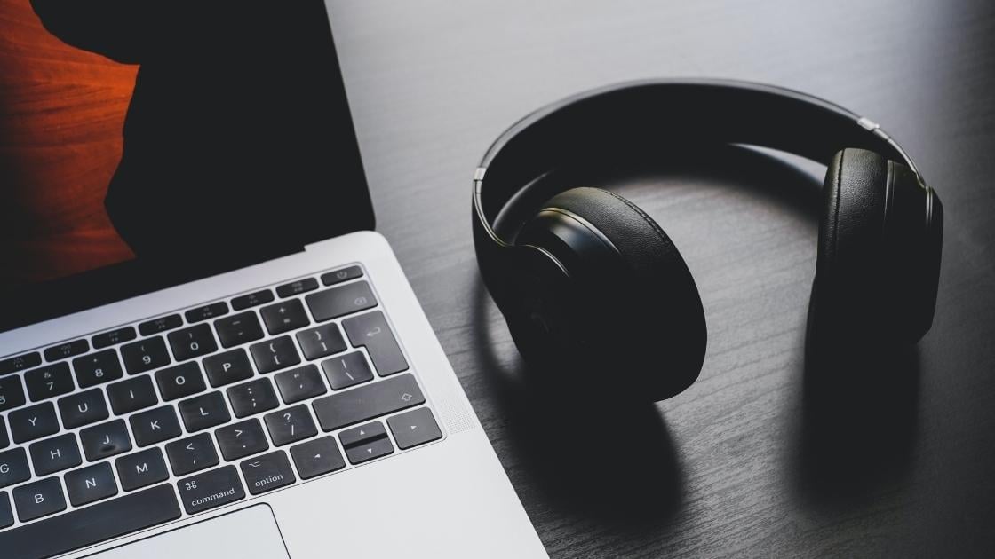 Computer and headphones representing Music API for Businesses