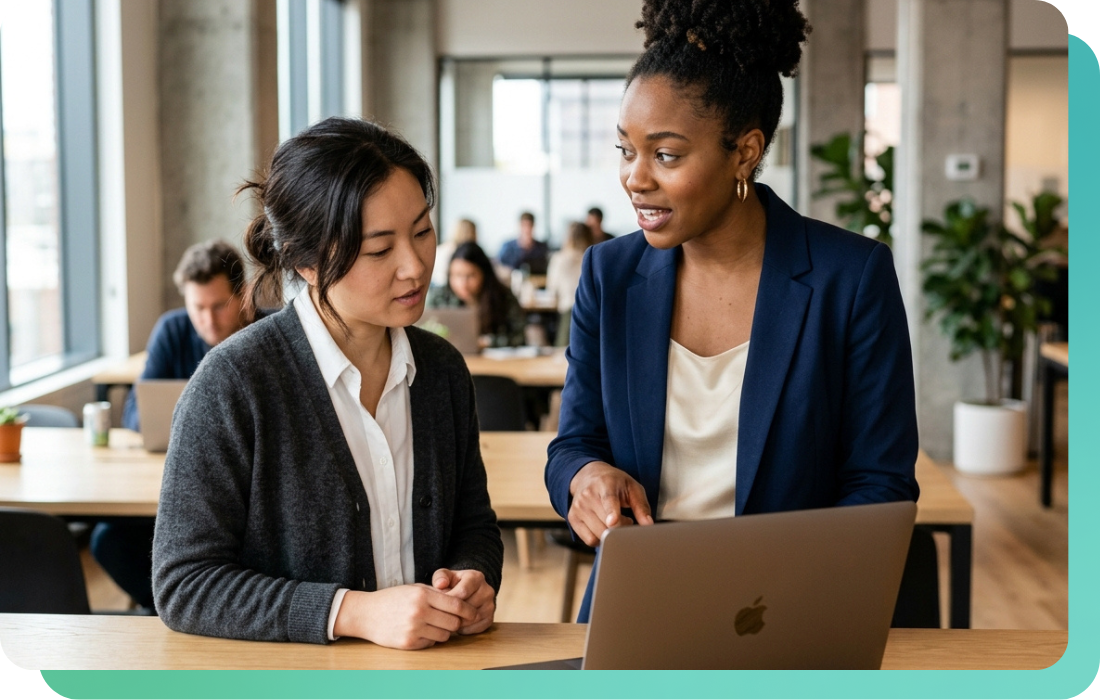Two product managers reviewing music API options on a laptop