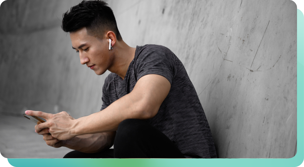 Man with airpods using phone