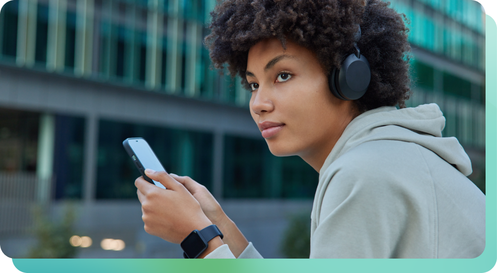 Woman with headphone and smart watch listening to music on phone