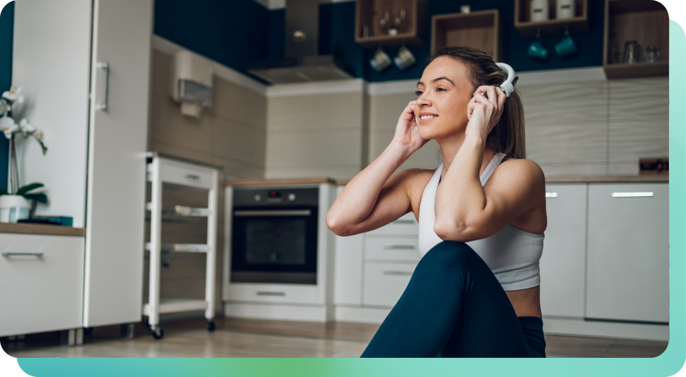 Woman listening to music on headphones in kitchen