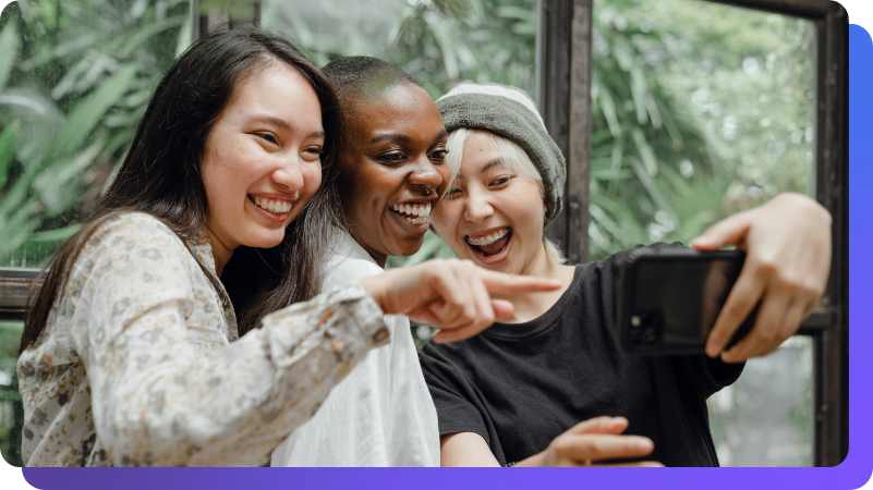 Friends looking at phone and smiling