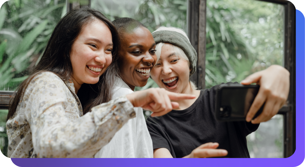 Group of people laughing at a phone