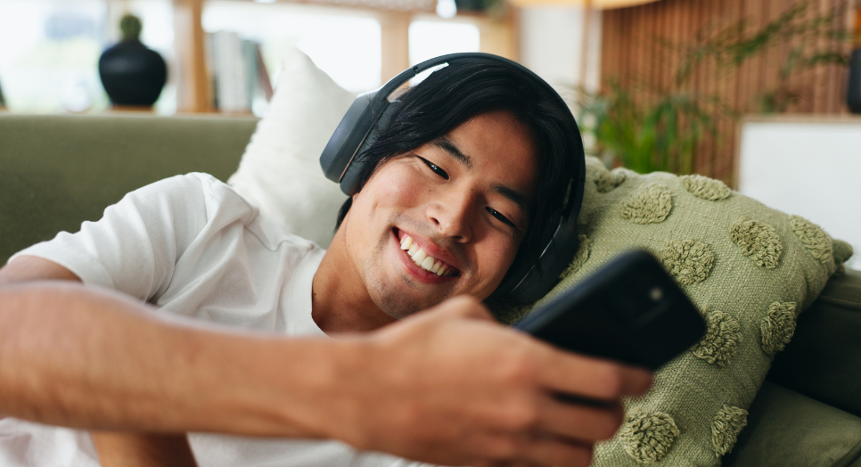 man on couch listening to music clip on messaging app
