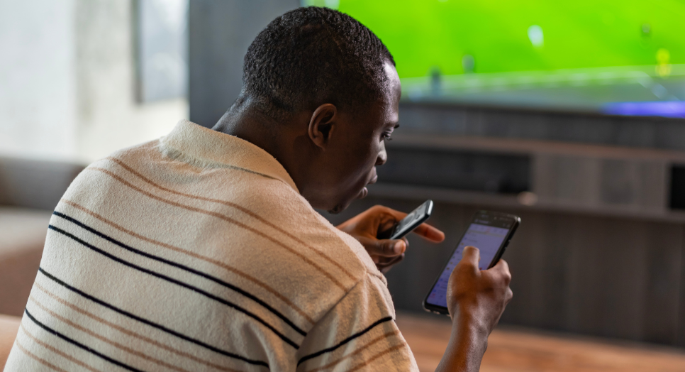 man watching sports looking at sports app