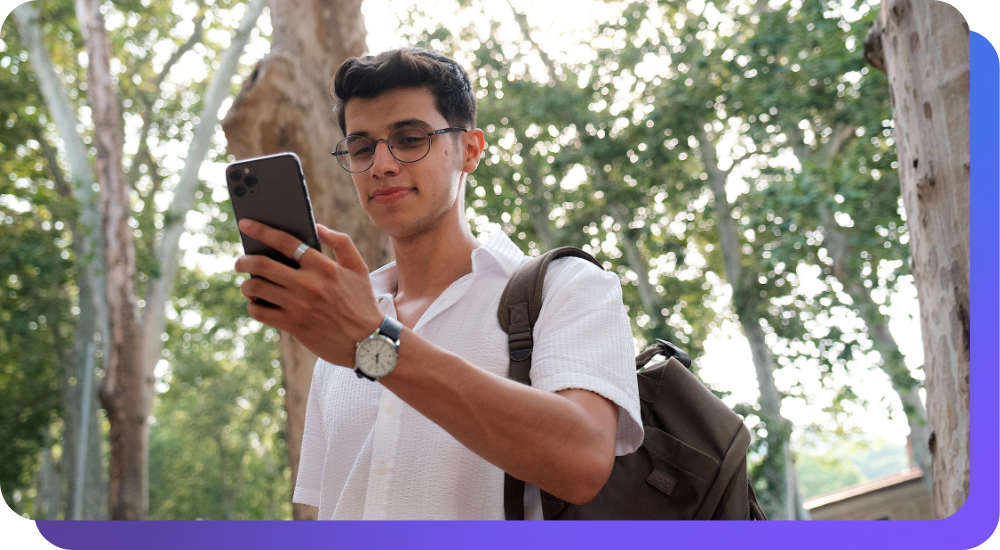 Man with backpack looking at phone