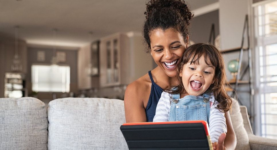 Mother daughter looking at family-friendly content on tablet