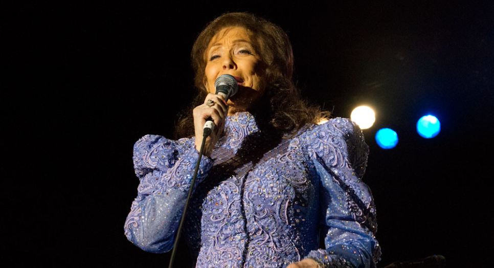 Loretta Lynn singing on stage