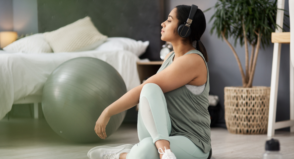 Woman stretching and listening to Feed.fm relaxing music